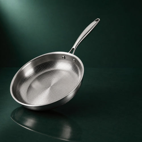 The Sunday Pan, 28cm solid-forged titanium, on a deep green background