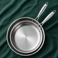 The Chef's Pair, 28cm and 24cm titanium pans nested on dark green cloth