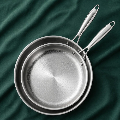 The Chef's Pair, 28cm and 24cm titanium pans nested on dark green cloth
